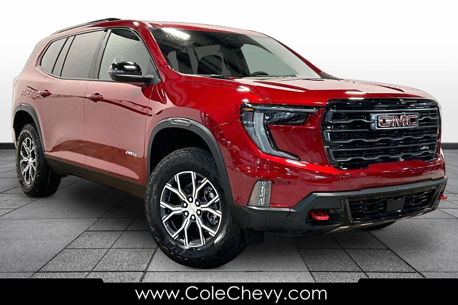 2026 GMC Acadia AT4 in Volcanic Red Tintcoat — front three-quarter view